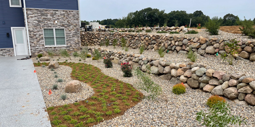 Home yard with custom landscape bed and rock mulch in Elkhart, IN.