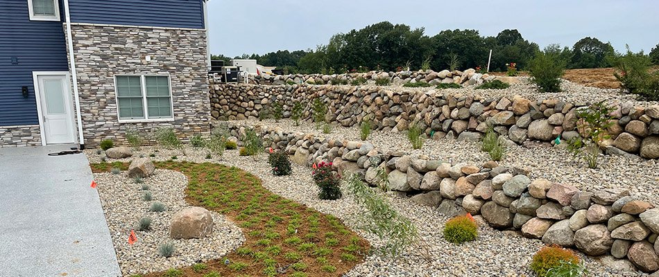 Before and after of landscaping bed cleanup and annual flowers  planted in a Granger, IN.