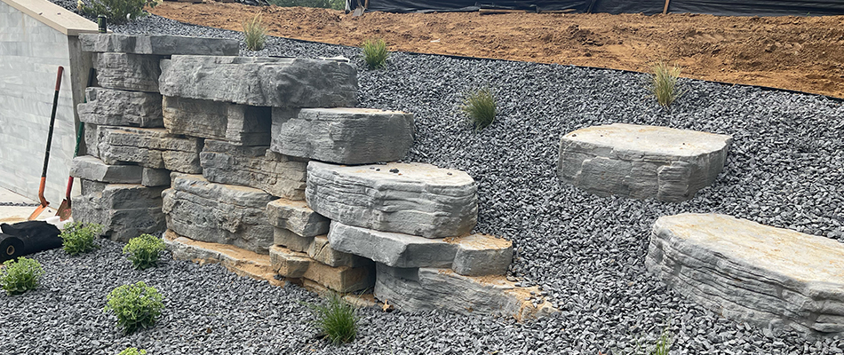 Custom stone retaining wall and patio with blazing fire pit near Elkhart, IN.