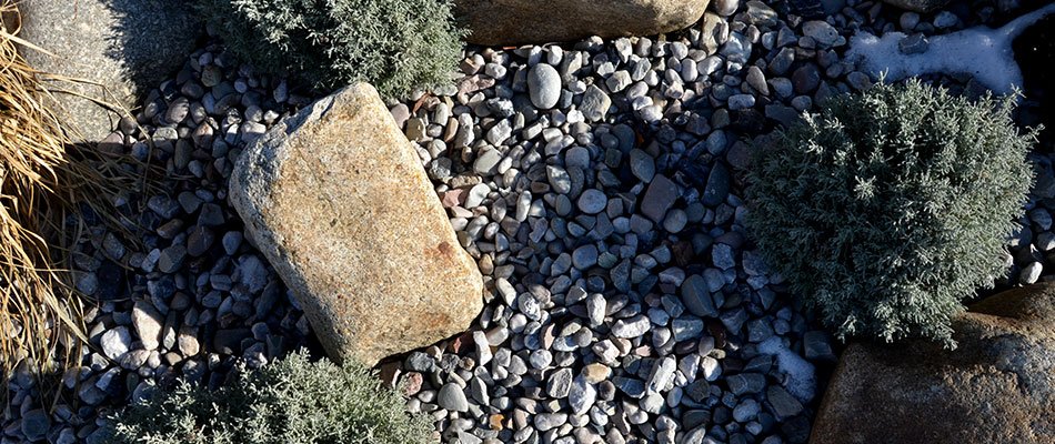 Landscape bed rocks he;ping retain water in winter in Elkhart, IN.